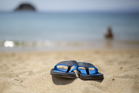 Blue flip-flop on the beachの写真素材