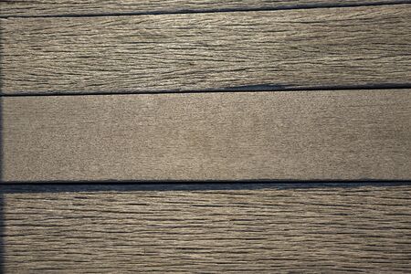 Brown weathered boardwalk planks background close-up.の写真素材