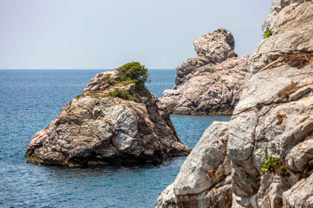 Big Rock in the blue waters of Stafilos Beach, Skopelos, Skopelos Island, Greece.の写真素材