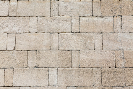 Stone wall fence rustic texture background close-up.