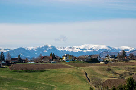 Panorama of a village in Austria against the background of snow-capped mountains in winter.の写真素材