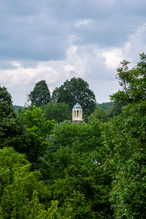 Orthodox church dome with cross above green foliage. Christian cathedral in a small village in Bulgarian woods.の写真素材