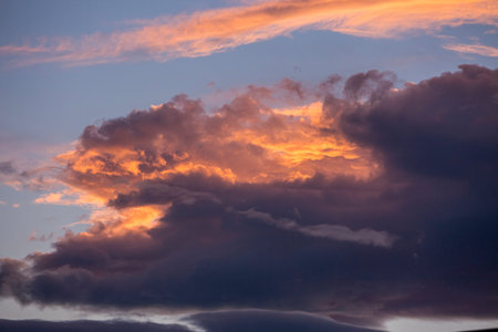 Colorful orange and blue dramatic sky with clouds for abstract background over Graz, Austria.
