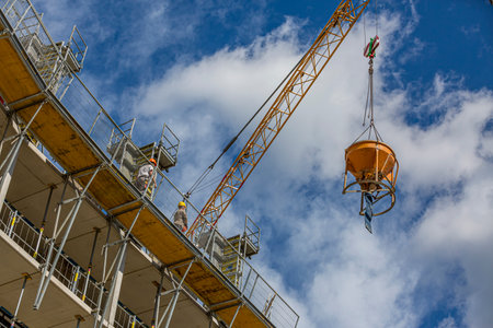 Worker operating a crane in a production facility.の写真素材