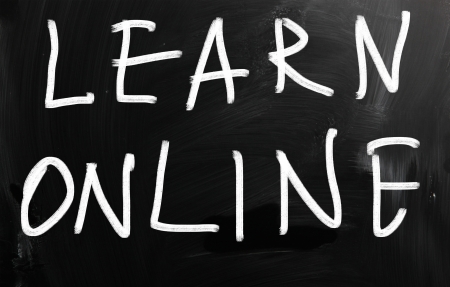 "Learn online" handwritten with white chalk on a blackboardの写真素材