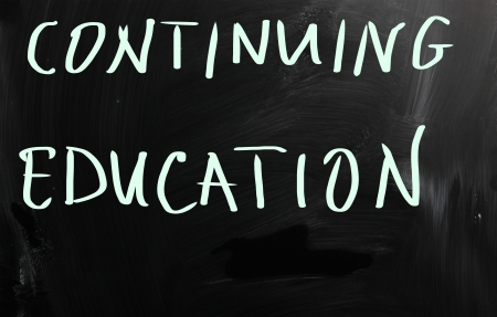  Continuing Education  handwritten with white chalk on a blackboardの写真素材