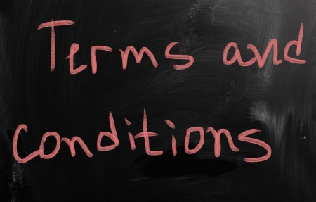 "Terms & Conditions" handwritten with white chalk on a blackboardの写真素材