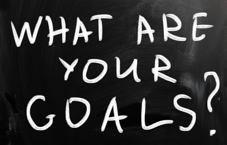 "what are your goals" handwritten with white chalk on a blackboardの写真素材