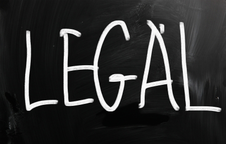 The word "Legal" handwritten with white chalk on a blackboardの写真素材