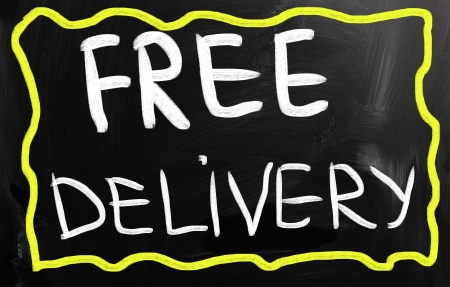 "Free delivery" handwritten with white chalk on a blackboardの写真素材