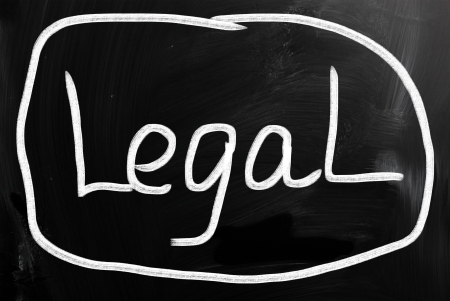 The word "Legal" handwritten with white chalk on a blackboard.の写真素材