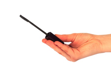 mascara in hand isolated on a whiteの写真素材