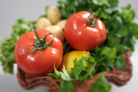 Tomatoes in a basket on a gray background-shallow dofの写真素材