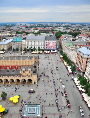 KRAKOW, POLAND - JULY 21: People on the Market Square in Krakow historical centre on July 21, 2012. Krakow is one the most beautiful and visited cities of Poland.のeditorial素材