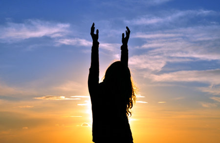 Woman silhouette with hands in the air