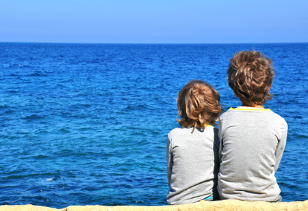 Small friends looking at horizonの写真素材