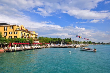 SIRMIONE, ITALY - JULY 14: View of a harbor with cafes and restaurants in Sirmione, Italy on July 14, 2014. Sirmione is a resort on Garda lake in northern Italy.のeditorial素材