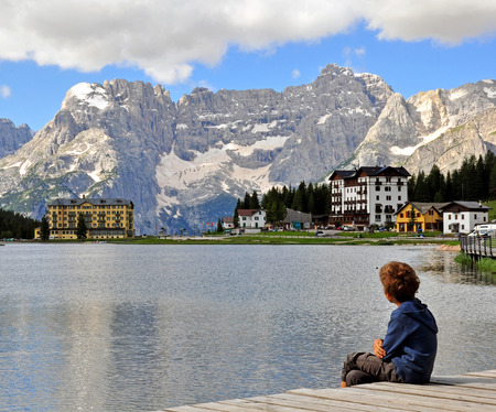 Boy looking at the Misurina lake, Italyの写真素材
