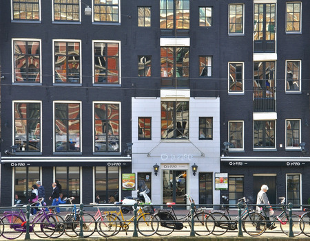 AMSTERDAM, NETHERLANDS - MARCH 27: Typical black houses on the street of Amsterdam city center on March 27, 2012. Amsterdam is the capital and most populous city of the Netherlands.のeditorial素材