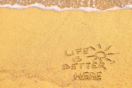 Life is better here word on sand の写真素材