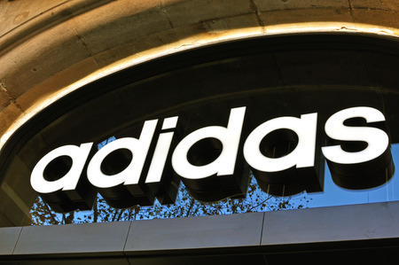 BARCELONA, SPAIN - DECEMBER 21: Logo of Adidas flagship store in the street of Barcelona on December 21, 2014. Adidas is a world famous sport brand.のeditorial素材