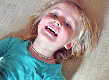 Smiling boy lying on the bedの写真素材