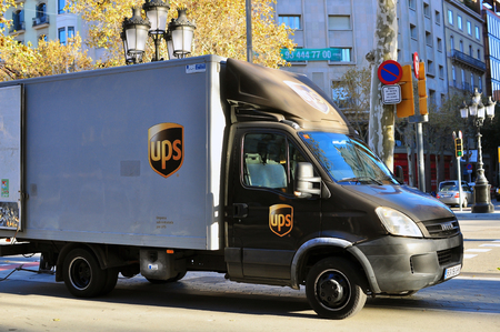 BARCELONA - DECEMBER 9: UPS delivery vehicle in the street of Barcelona on December 9, 2014. TNT is a company providing international delivery services.のeditorial素材