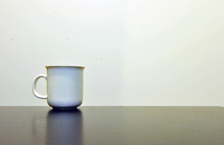 White cup on the tableの写真素材