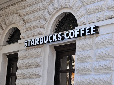 BUDAPEST, HUNGARY - MAY 16: Starbucks coffee sign on coffeeshop in Budapest on May 16, 2016. Starbucks is the largest coffeeshop chain in the world.のeditorial素材