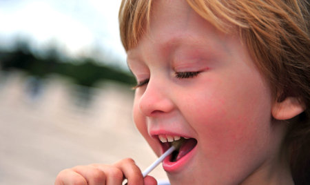 Portrait of a boy with a lollipop