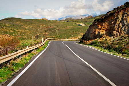 Asphalt road in mountains with the blue skyの写真素材