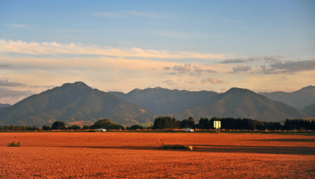 Two cars moving on highway with mountains on backgroundの写真素材