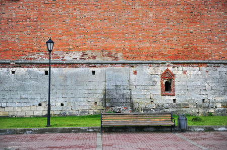 Lantern and bench with red brick wall on backgroundの写真素材
