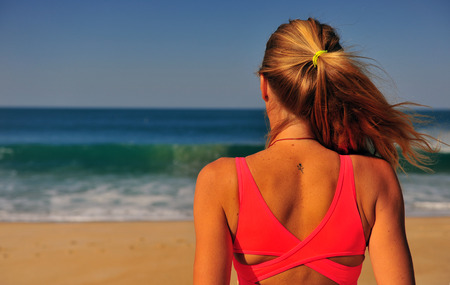 Blond woman standing at sea on summerの写真素材