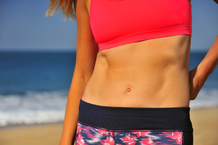 Slim body of an athletic woman outdoorsの写真素材