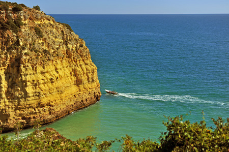 Touristic boat near the cliff at Carvoeiro, Portugalの写真素材
