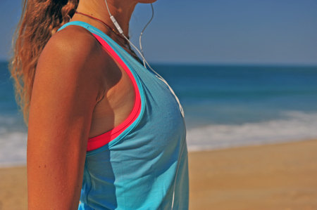 Athletic woman listening to the music outdoors