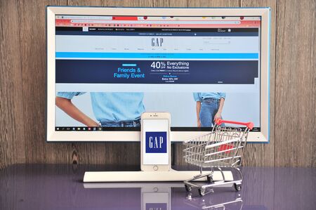 Yaroslavl, Russia - August 14, 2019: Gap logo in mobile phone awith website on background on August 14, 2019.のeditorial素材