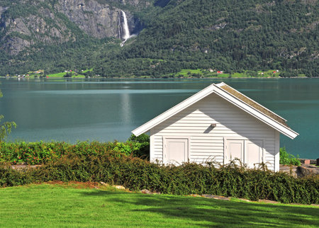Traditional scandinavian wooden house at lake, Norwayの写真素材