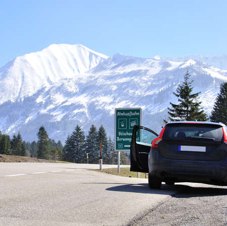 Car in front of mountain range in Alps, Germanyの写真素材