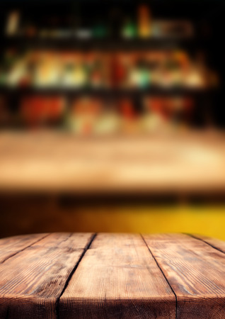 Wooden table in the pub bar, dark interior.の写真素材