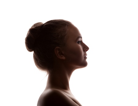  woman portrait profile  in silhouette shadow on studio isolated white background の写真素材