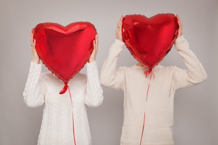 The girl and the guy with balloons in the form of heartの写真素材