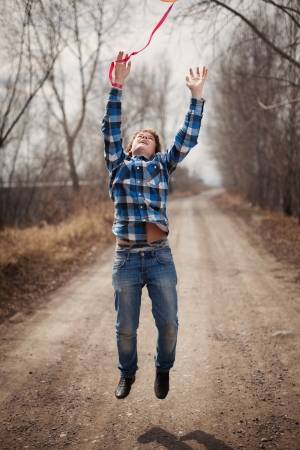 The cheerful boy with a balloon on outdoorsの写真素材