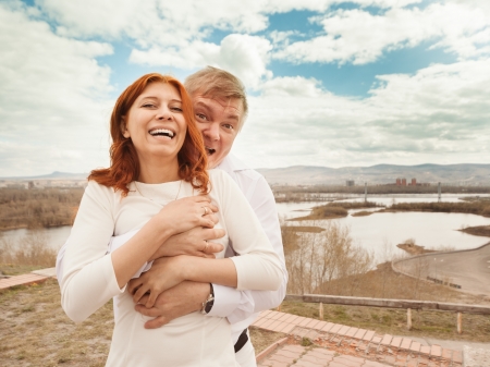 Happy couple embracing and laughingの写真素材