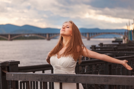 Free happy young woman enjoying nature. Beauty girl outdoor. の写真素材