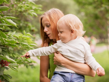 young woman with her baby son in the park の写真素材