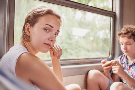 Teenagers girl and boy in the commuter trainの写真素材