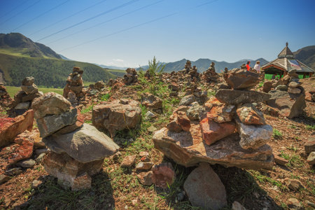 Pyramid of stones on a background of mountains on the observation deck at the confluence of the...