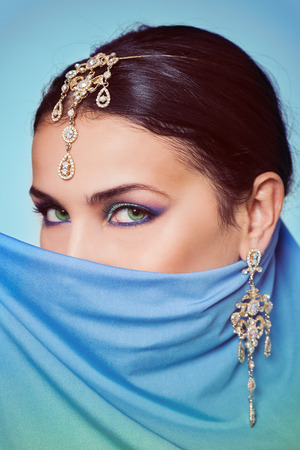 Bright makeup woman with golden adornmentの写真素材